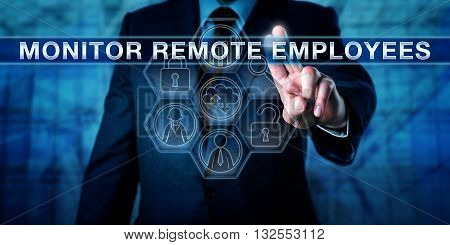 HR manager is pressing MONITOR REMOTE EMPLOYEES on an interactive virtual touch screen. Business metaphor and information technology concept for supervision of bring-your-own-device work practices.