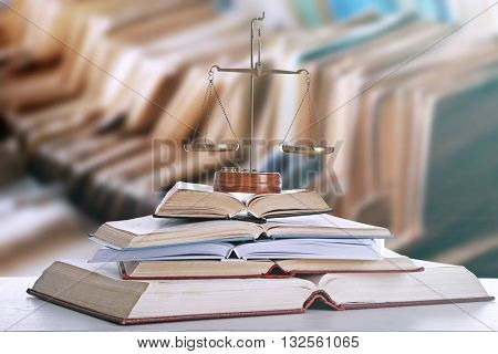 Justice scales on table in library