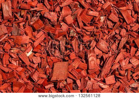 Sloping green lawn. Red lawn wood chips of different sizes