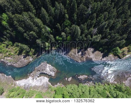 arial shot of a river through a forest