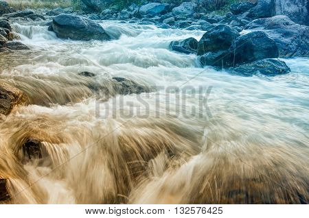 Beautiful Reshi River water flowing through stones and rocks at dawn Sikkim India. Reshi is one of the most famous rivers of Sikkim flowing through the state and serving water to many local people.