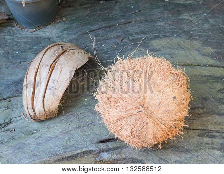 Coconut and the shell on Wood floor blur background. (select focus Coconut)