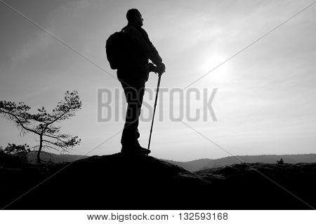 Tourist In Windcheater With Sporty Trecking  Poles In Hands Stand On Rocky View Point.