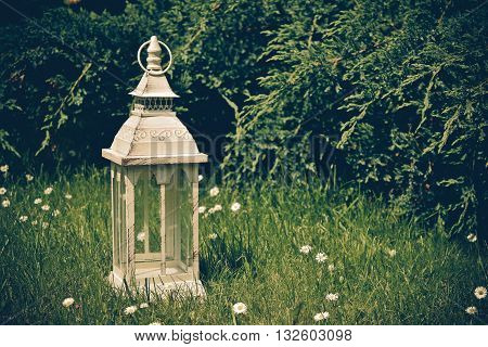 lantern on grass in vintage style. Garden decor