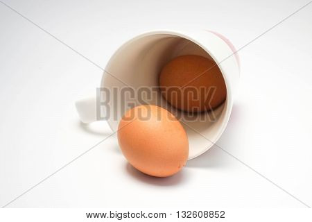 Coffee cup with eggs in white background