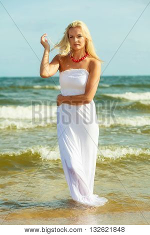Attractive Blonde Woman On The Beach.