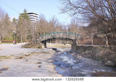 Delicate bridge across the mountain river Olkhovka in city Kislovodsk