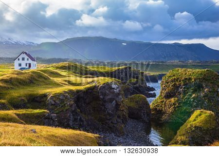 Sunset in the fishing village of Arnastapi. Quiet summer evening on the coast of Iceland