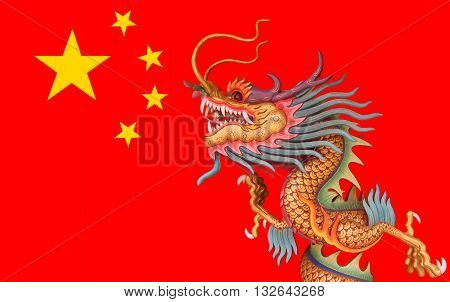 golden Chinese dragon statue on red China flag