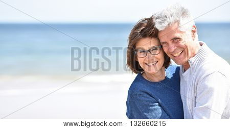 Senior couple embracing each other at the beach