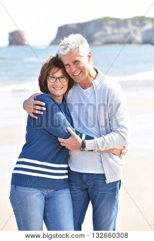 Senior couple embracing each other at the beach