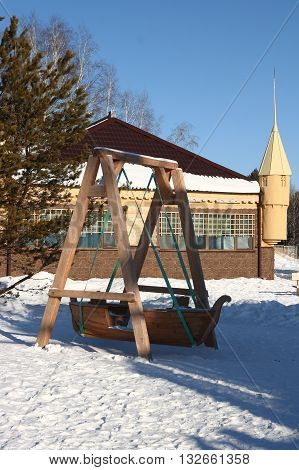 Children's wooden swing is made in the form of boats.