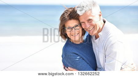 Senior couple embracing each other at the beach