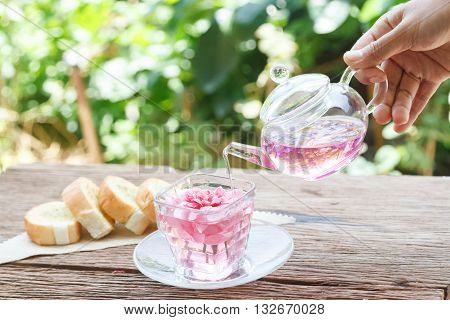 Afternoon tea break rose tea with tea pot in the garden
