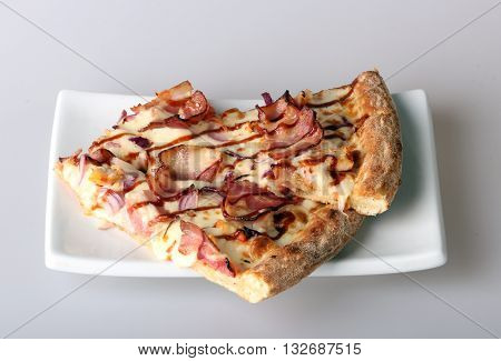 yummy pizza on the white square plate