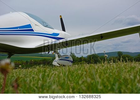 small sport aircraft at the airport , green grass