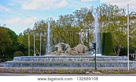 A beautiful fountain with a medieval monument. Spain.