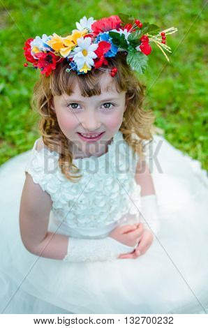 Smiling girl with a wreath on his head