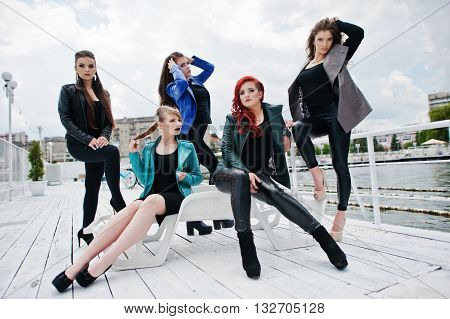 Five Beautiful Young Girls Models At Leather Jackets Posing On Berth.