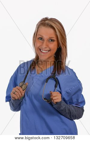 Blonde woman wearing blue scrubs holding a stethoscope. Female doctor or nurse