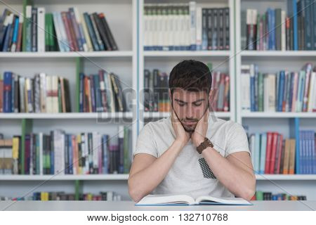 Student reading book in school library. Study lessons for exam. Hard worker and persistance concept.