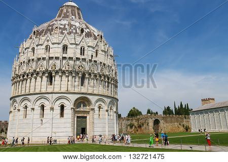 Pisa Italy - June 29 2015: Tourists near the Baptistery of St. John (Battistero di San Giovanni). Province Pisa Tuscany region of Italy