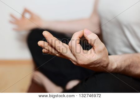 sitting man is doing yoga meditation on floor