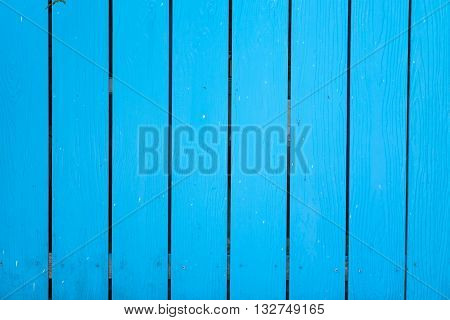 Textured wood planks painted in blue background