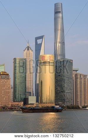 SHANGHAI CHINA - MARCH 25: Pudong district view from The Bund waterfront area on March 25 2016 in Shanghai China. Pudong is a district of Shanghai located east of the Huangpu River.