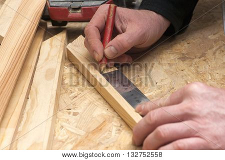 carpenter working hammermeter and screw-driver on construction background.