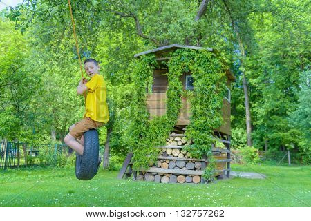 Smiling boy on treehouse. Summer time!