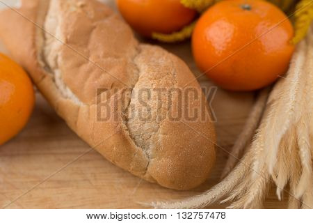 French Bread Baguettes On Bread Board And Mandarin Oranges
