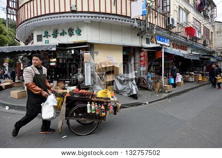 SHANGHAI CHINA - MARCH 19: Unidentified Chinese people trades traditional food on March 19 2016 in Shanghai China. Shanghai is the largest Chinese city by population.