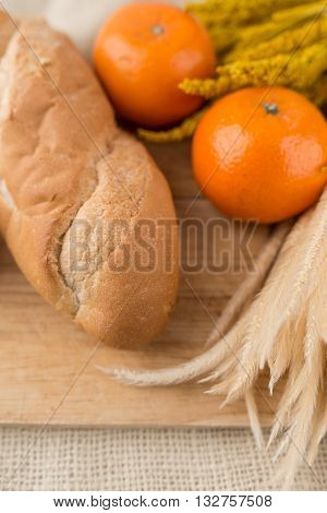 French Bread Baguettes On Bread Board And Mandarin Oranges