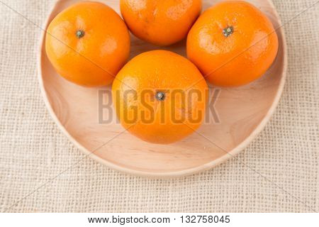 Group Of Mandarin Oranges, Tangerines Fruit On Burlap Sack Background