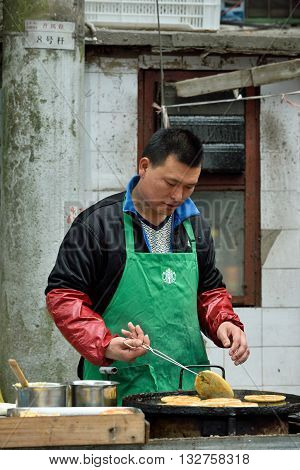 SHANGHAI CHINA - MARCH 19: Unidentified Chinese people trades traditional food on March 19 2016 in Shanghai China. Shanghai is the largest Chinese city by population.
