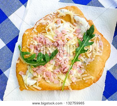 Warm Langos With Cheese, Ham And Arugula