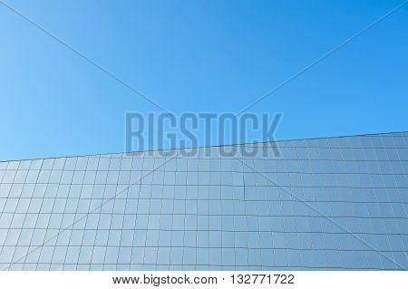 Facade of a modern building against the blue cloudless sky