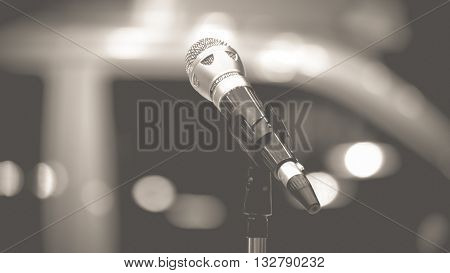 Microphone in seminar event defocus on background process in vintage black and white style.