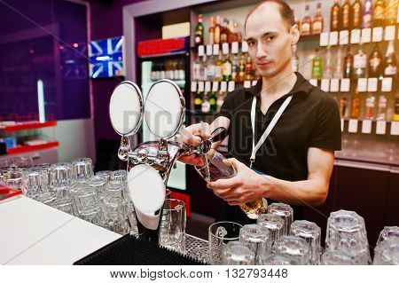 Bartender Pours A Beer At The Bar In The Club