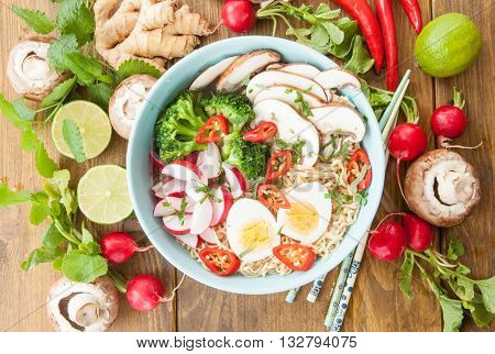 Asian ramen noodle soup with fresh veggies and hardboiled egg