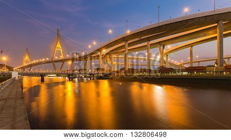 Highway intersection connect to suspension river front at twilight