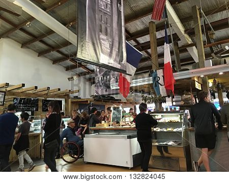 AUCKLANDJUNE 4: Food lovers gather to buy and taste top quality products from both New Zealand artisan producers and growers and from overseas at the La Cigale French Market in Auckland New Zealand on June 4 2016.