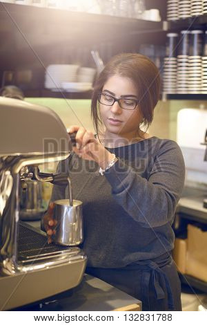 Female Barista Or Waitress Making Cappuccino