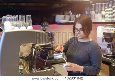 Female Barista Or Waitress Making Cappuccino
