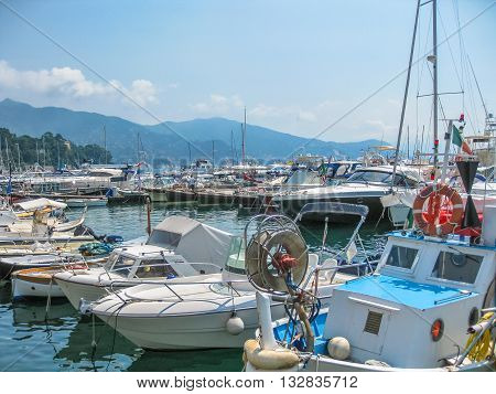Santa Margherita Ligure, Liguria, Italy - circa June 2010: fishing boats, sailboats and motorboats in the port of one of the most popular resorts on Italian Ligurian coast in summer.