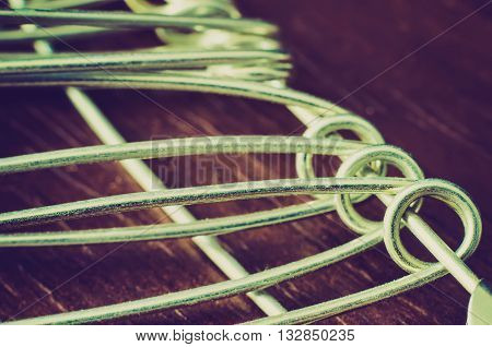 a lot of pinheads on a wooden background