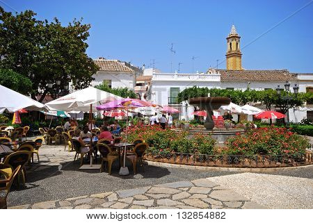 ESTEPONA, SPAIN - JULY 18, 2008 - Fountain and pavement cafes in the Plaza las flores Estepona Malaga Province Andalucia Spain Western Europe, July 18, 2008.