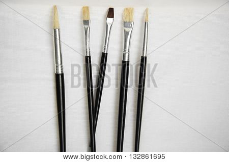black five paint brushs on white background