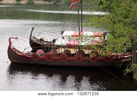 Koknese Latvia - 14 May 2016: The tourist boat in the style of a Viking ship on the river Perse. Perse is a tributary to Daugava River in Latvia.